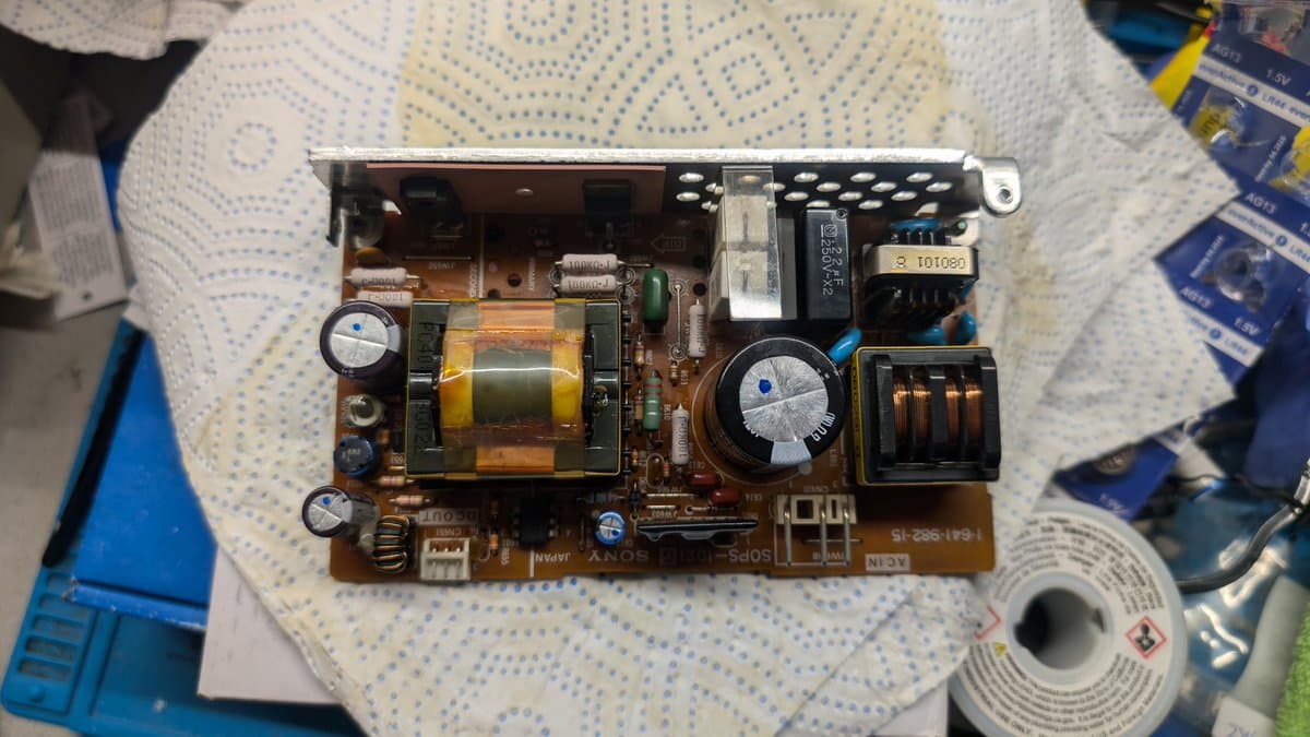 Sony PVM-9045QD PSU board with reflowed solder joints, capacitors, transformer, and inductor coils visible during restoration.