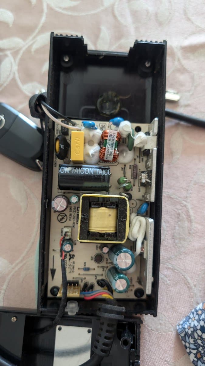 Xbox 360 E PSU board with failed Taicon and LTEC capacitors, showing oxidation damage and corrosion requiring recap and reflow repair.