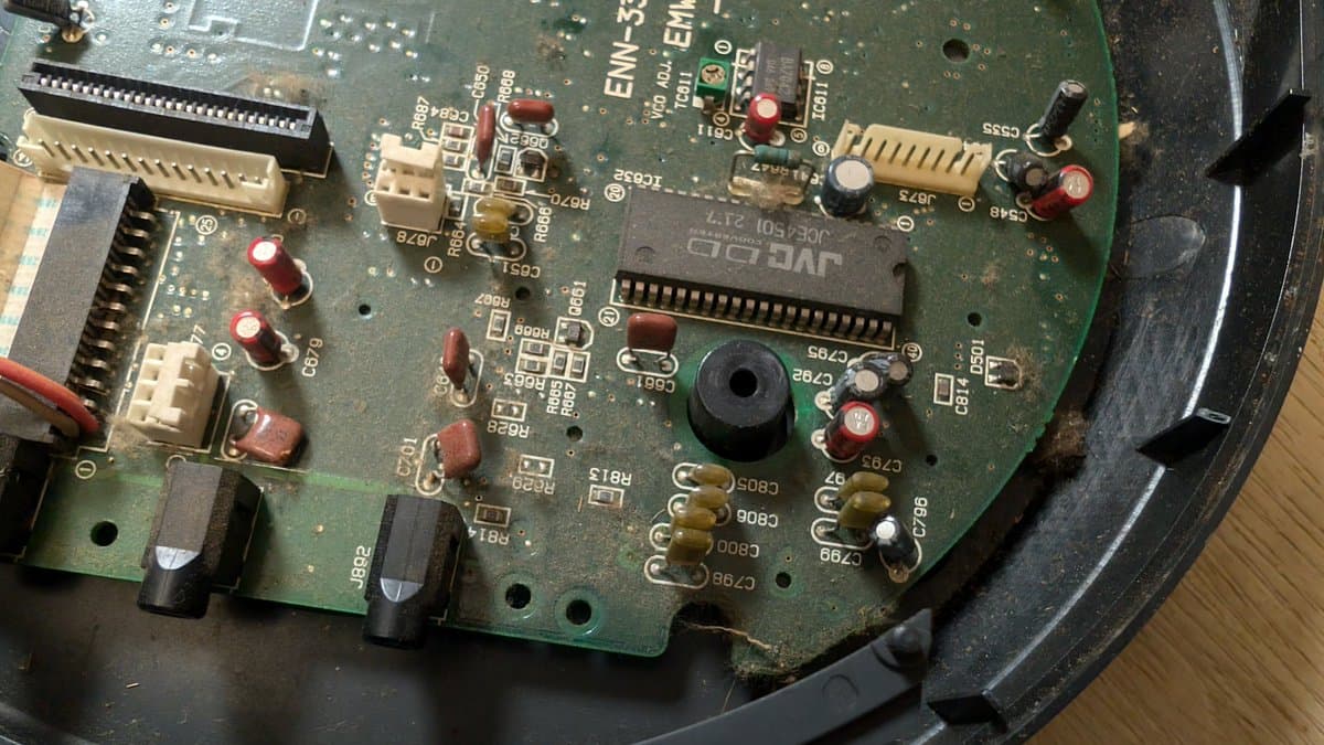 Wondermega main board showing corrosion damage, missing components, broken traces, and deteriorated solder joints requiring restoration work.