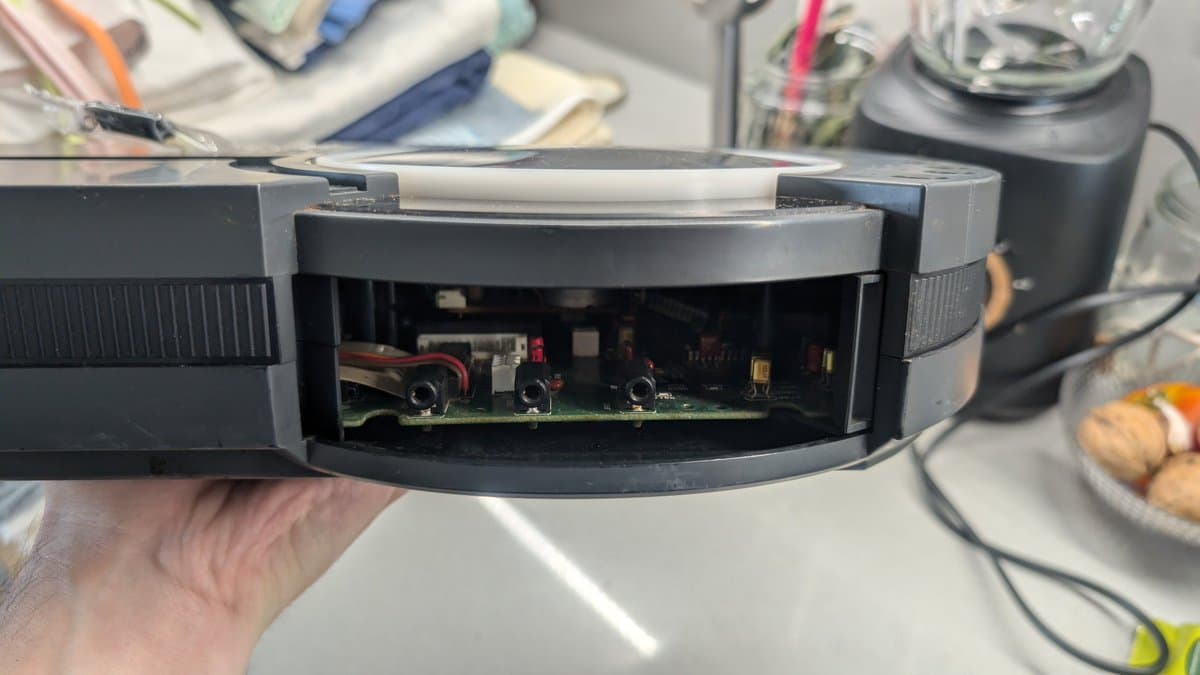 Sega Wondermega HWM-5010 motherboard interior showing corroded components, missing screws, and damaged circuitry during restoration assessment.