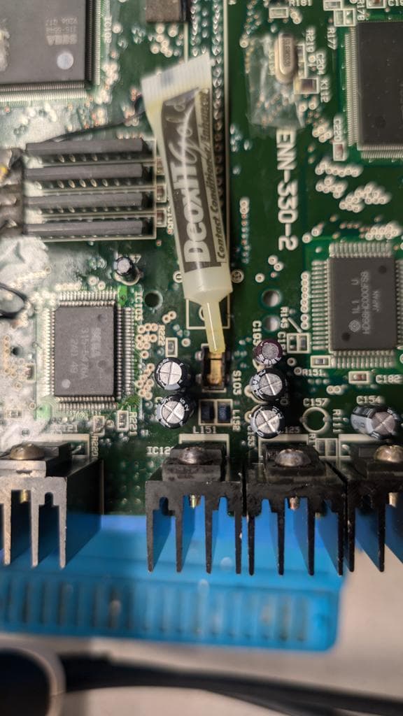 Wondermega cartridge slot connector pins cleaned during restoration, blue plastic guide visible at bottom of board.