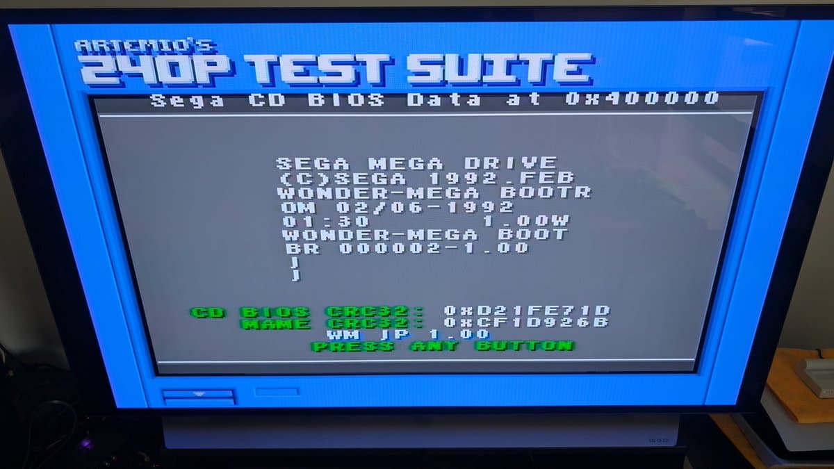 Artemio's 240p Test Suite running on Sega Wondermega, showing BIOS and CD check passing at 0x900000 memory address.