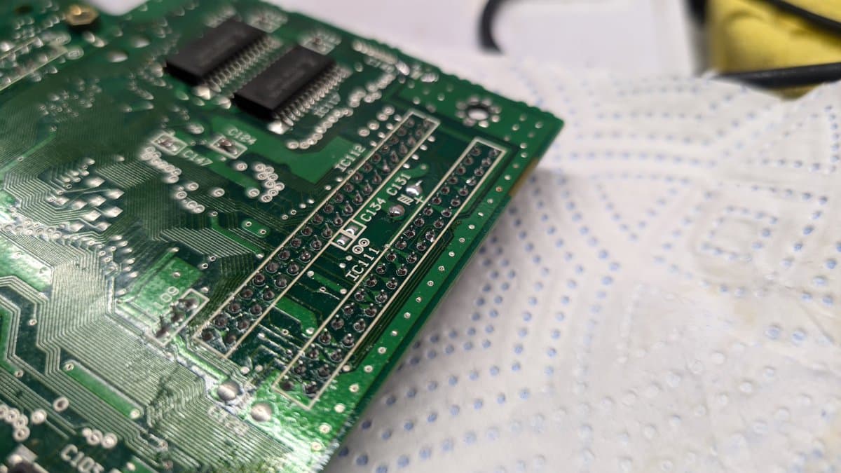 Sega Wondermega PCB with installed RAM package from MCD1 donor board, showing solder joints and component placement after repair attempt.