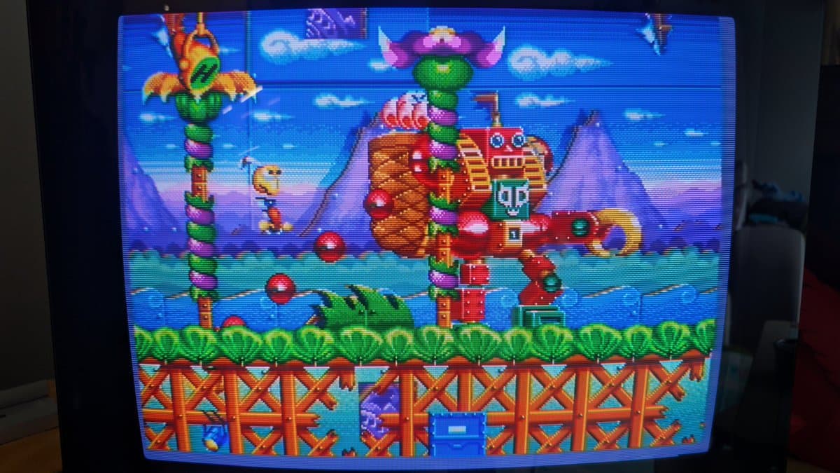 Sega Mega-CD game Road Avengers running on restored Wondermega, showing colorful stage with mechanical castle and totem poles.