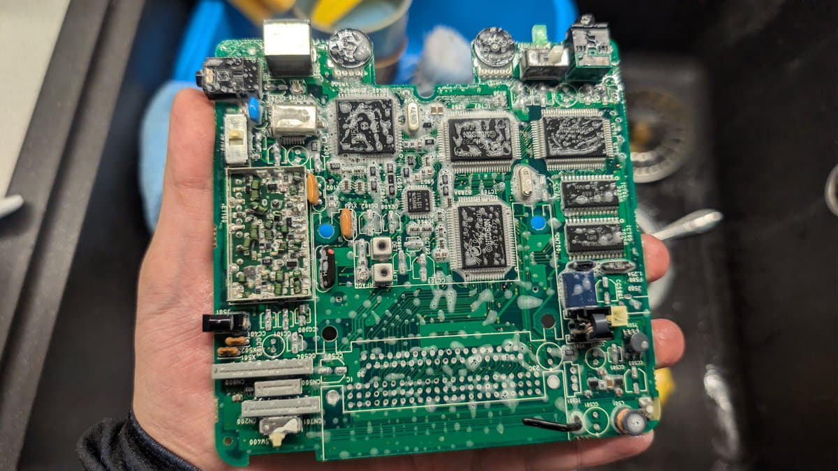 NEC PC Engine LT mainboard after ultrasonic cleaning, showing multiple ICs, capacitors, and connectors with no visible broken traces or corrosion damage.