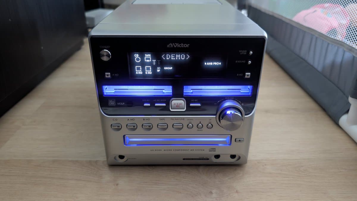 Victor UX-W800 MiniDisc micro component system with illuminated display showing demo mode, featuring CD, MD, and cassette playback capabilities.