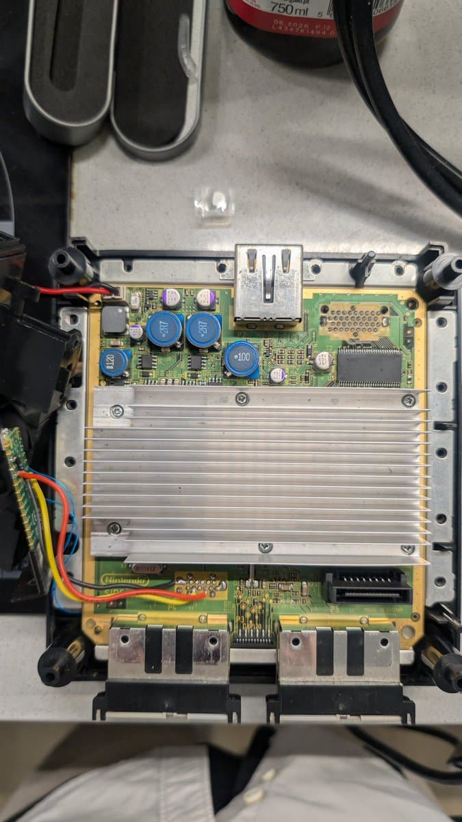 PAL DOL-101 GameCube mainboard with PicoBoot/WiiKey mod installed, showing mostly polymer capacitors, minimal recap work required.