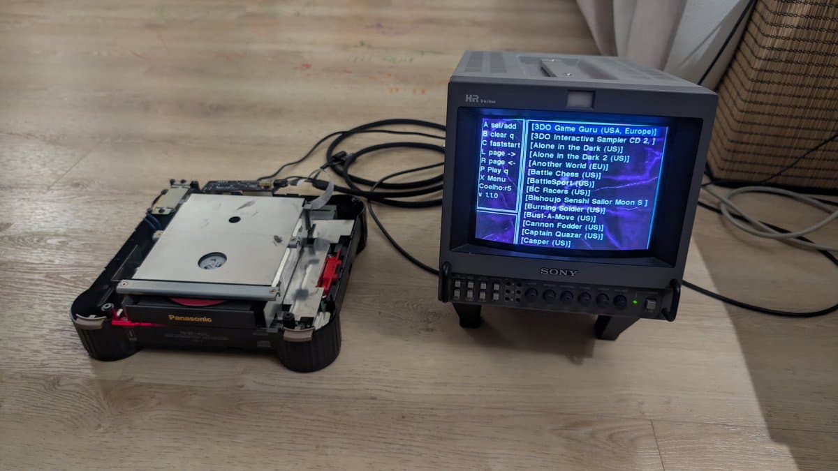 Panasonic FZ-1 3DO connected to Sony monitor displaying game menu; console shows internal repairs with exposed PCB and ribbon cables during ODE installation.