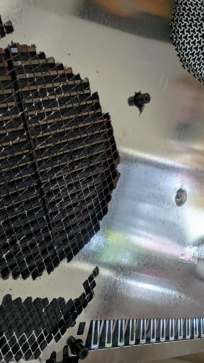 Xbox 360 E motherboard with corrosion on metal RF shields after evaporust treatment; repair workbench overview.