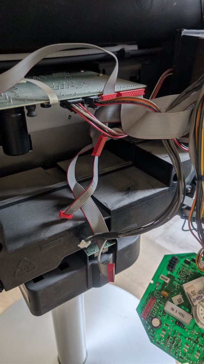 Disconnected ribbon cables and wires inside B&O Beovision 1 chassis during investigation of X2 safety cap failure that caused smoke damage.