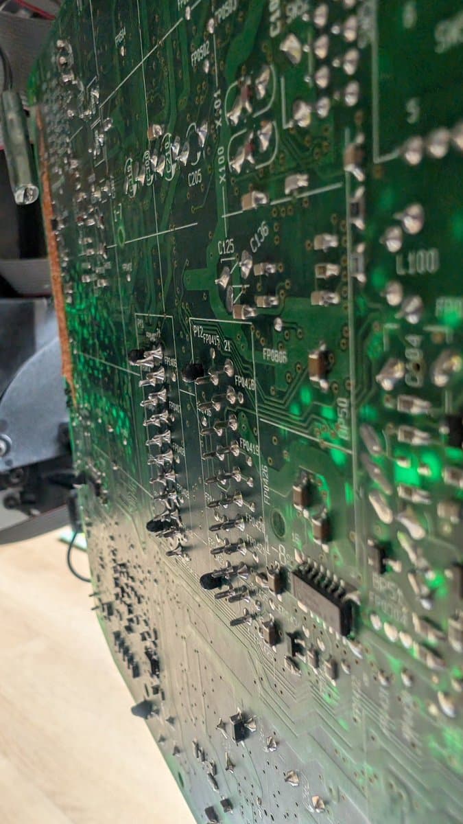 Close-up of B&O Beovision 1 PCB showing reflowed SCART port solder joints and surrounding circuitry during troubleshooting.