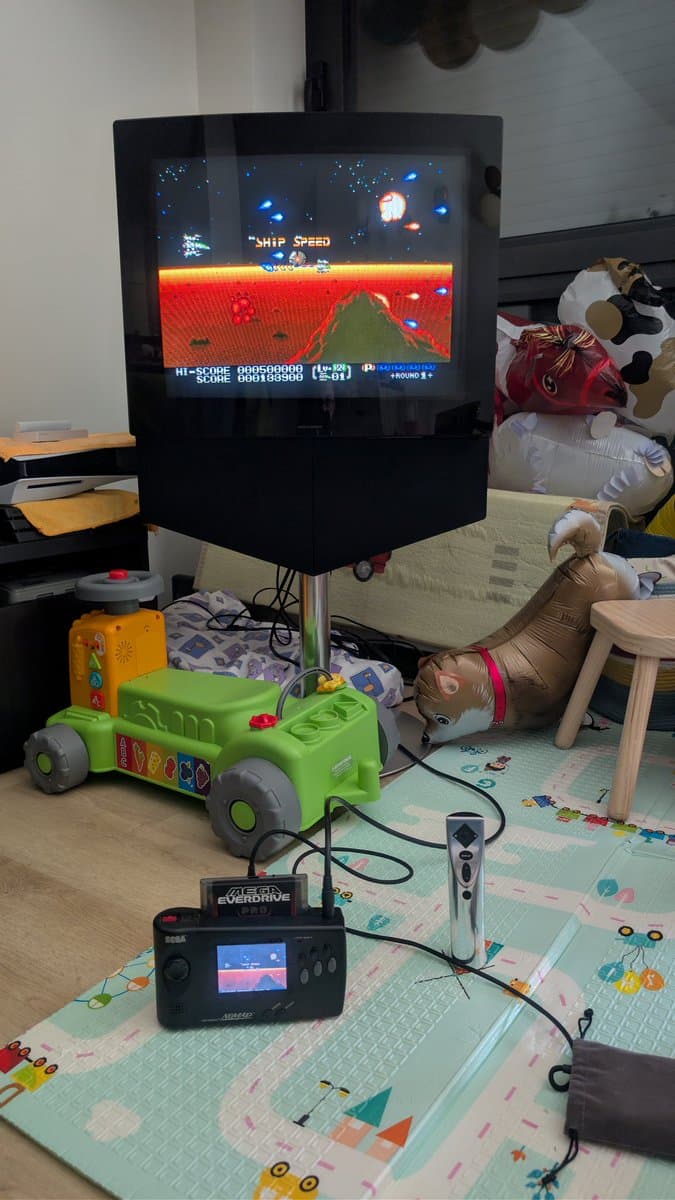 Beovision 1 CRT displaying arcade game with Sega Mega Drive controller below; new KEMET safety cap installed post-repair.